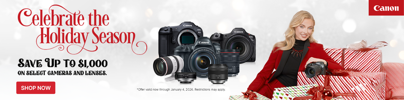 Promotional banner for Canon cameras during the holiday season with a woman holding a camera and presents.