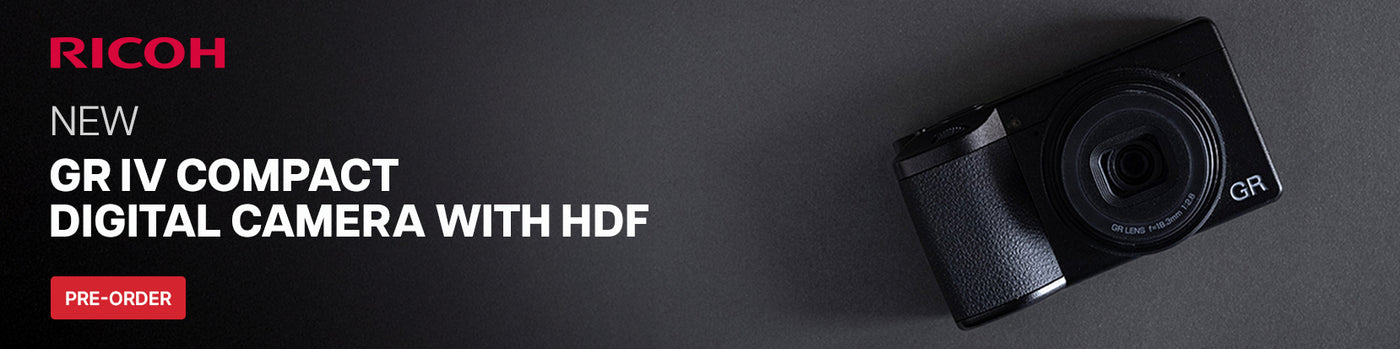 Ricoh GR IV compact digital camera with HDF on a dark background
