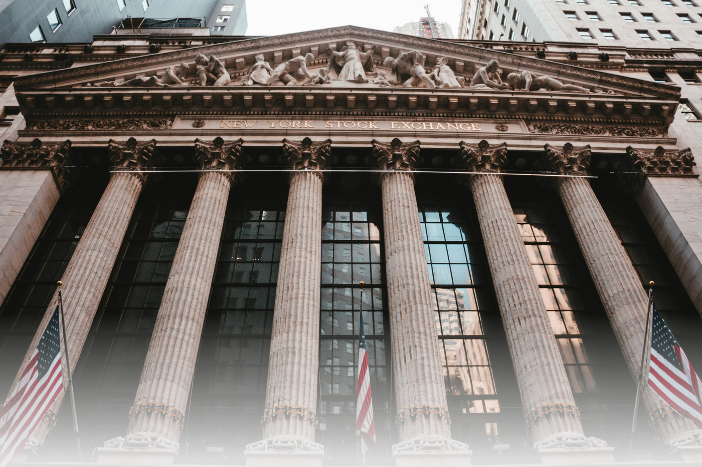 Facade of a classical building with columns and American flags