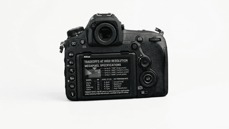 A technical close-up showing specific megapixel counts for distinct camera bodies on a screen and guide