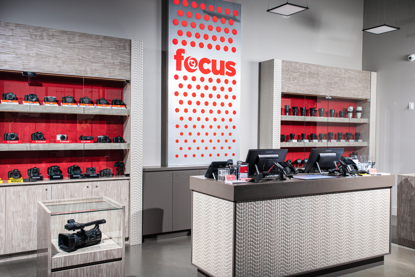 Store interior with 'focus' branding, shelves with products, and a counter.
