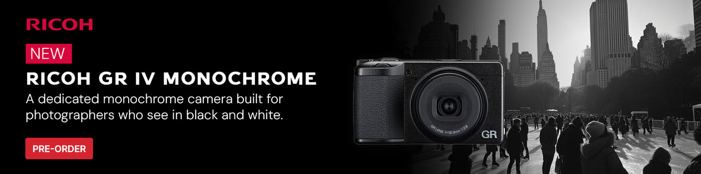 New from Ricoh GR IV Monochrome Camera on black background with photo of ice skaters and city skyline next to it
